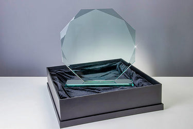 Awards Berlin - 420x395 mm PK765078, elegant lasergraviert, ruht in einer schwarzen Geschenkbox, die mit schwarzem Stoff ausgekleidet ist. Der Hintergrund ist ein einfacher grauer Farbverlauf.